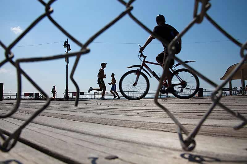 USING A FOUND FRAME. For this shot on Coney Island Boardwalk in New York, I placed my self low behind a gap in the fence and waited for some interesting geometric shapes to occupy the frame I had created. It’s interesting to shoot through gaps like this as one adds layers and context to the photograph.