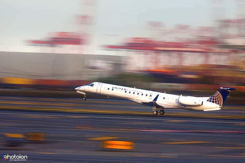 panned photo of a jet taking off